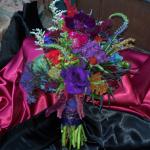 A dark , rich cluster bouquet of
Purple Lisianthus, Veronica, Purple Hydrangeas, Amaranthys, Yarrow, Trechelum, Celosia, Bella Donna, Anemone and Clover. 